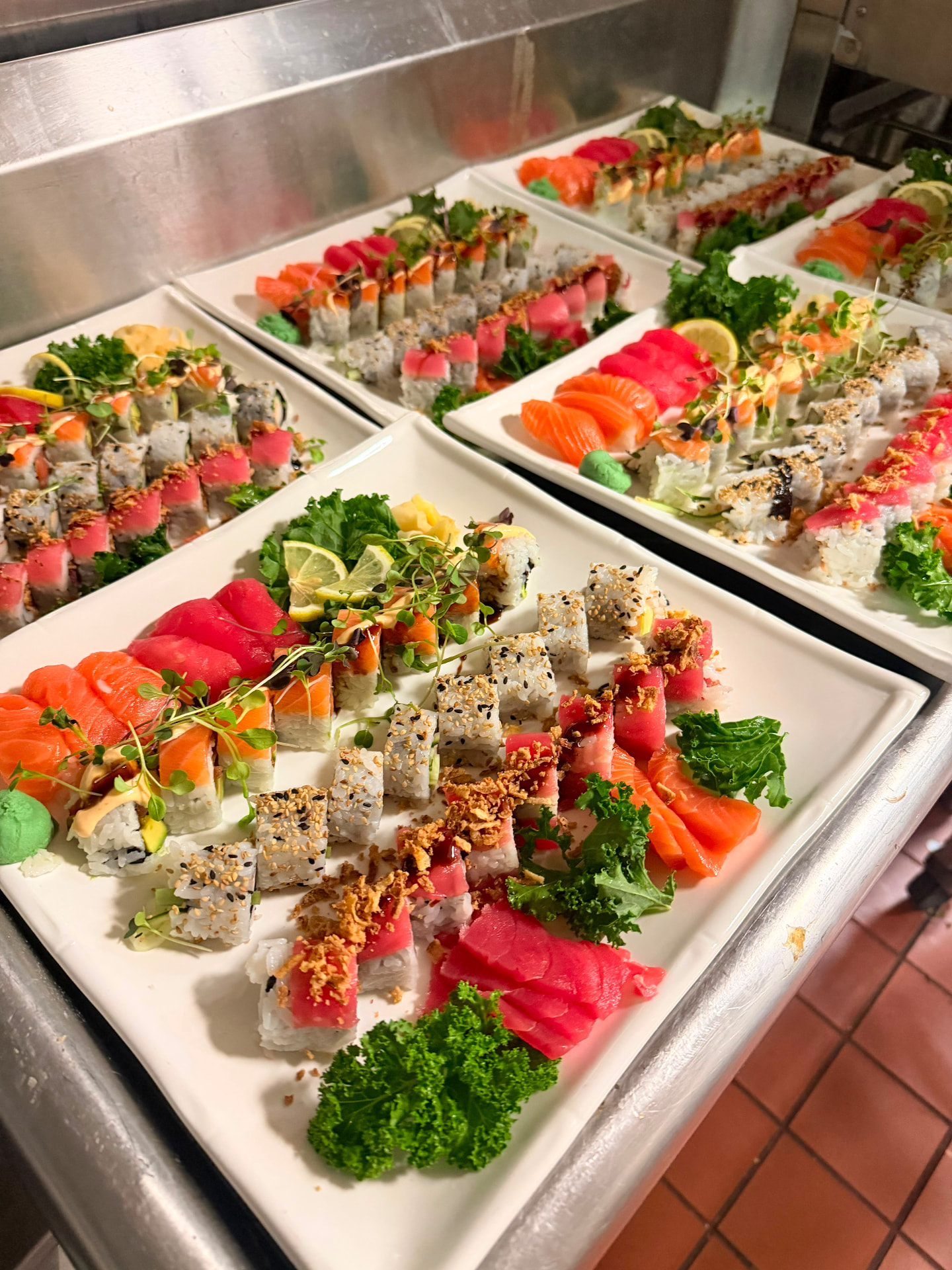 Platters of salmon and tuna rolls plated for service