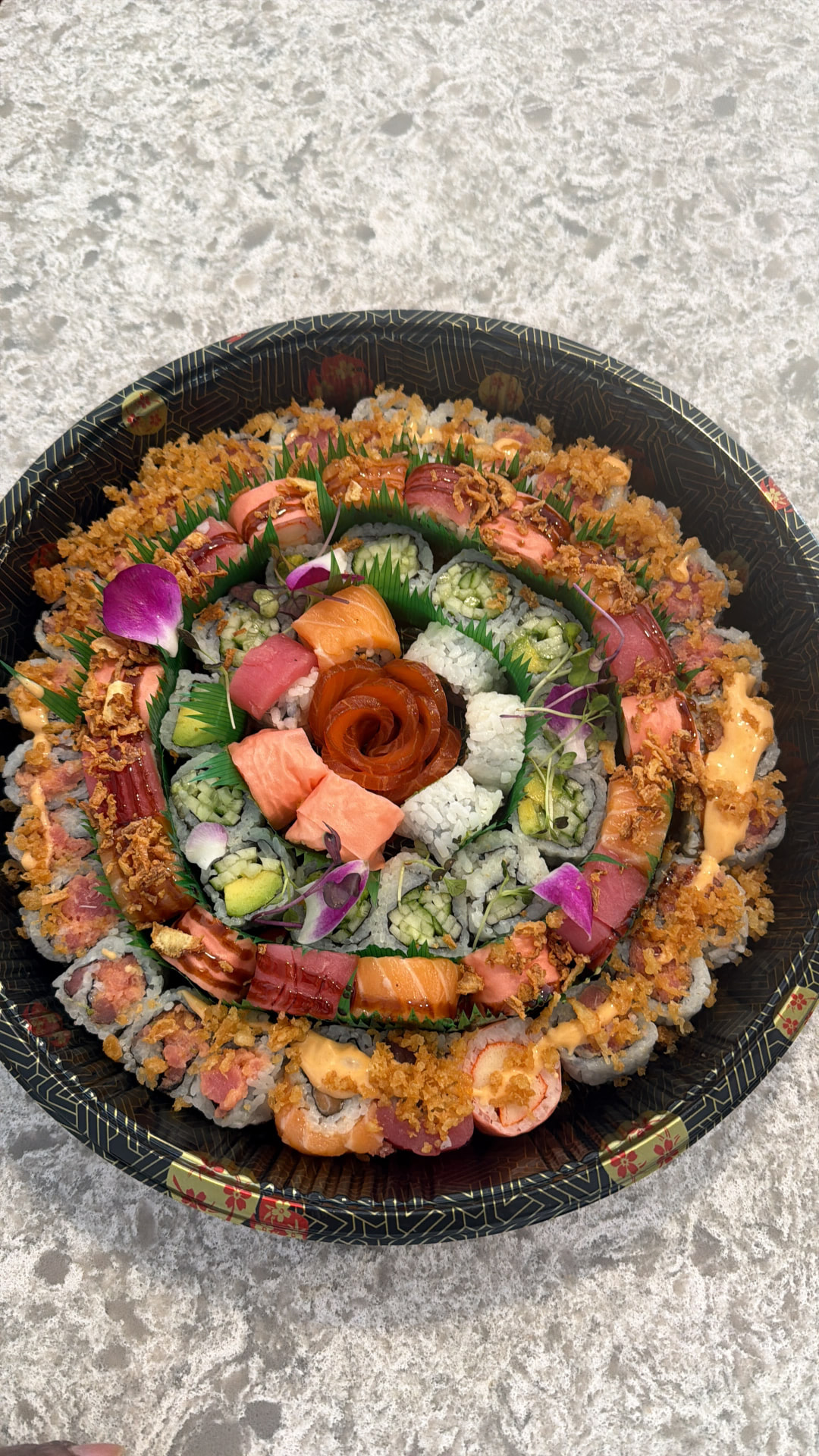 Circular sushi platter with a salmon rose centrepiece