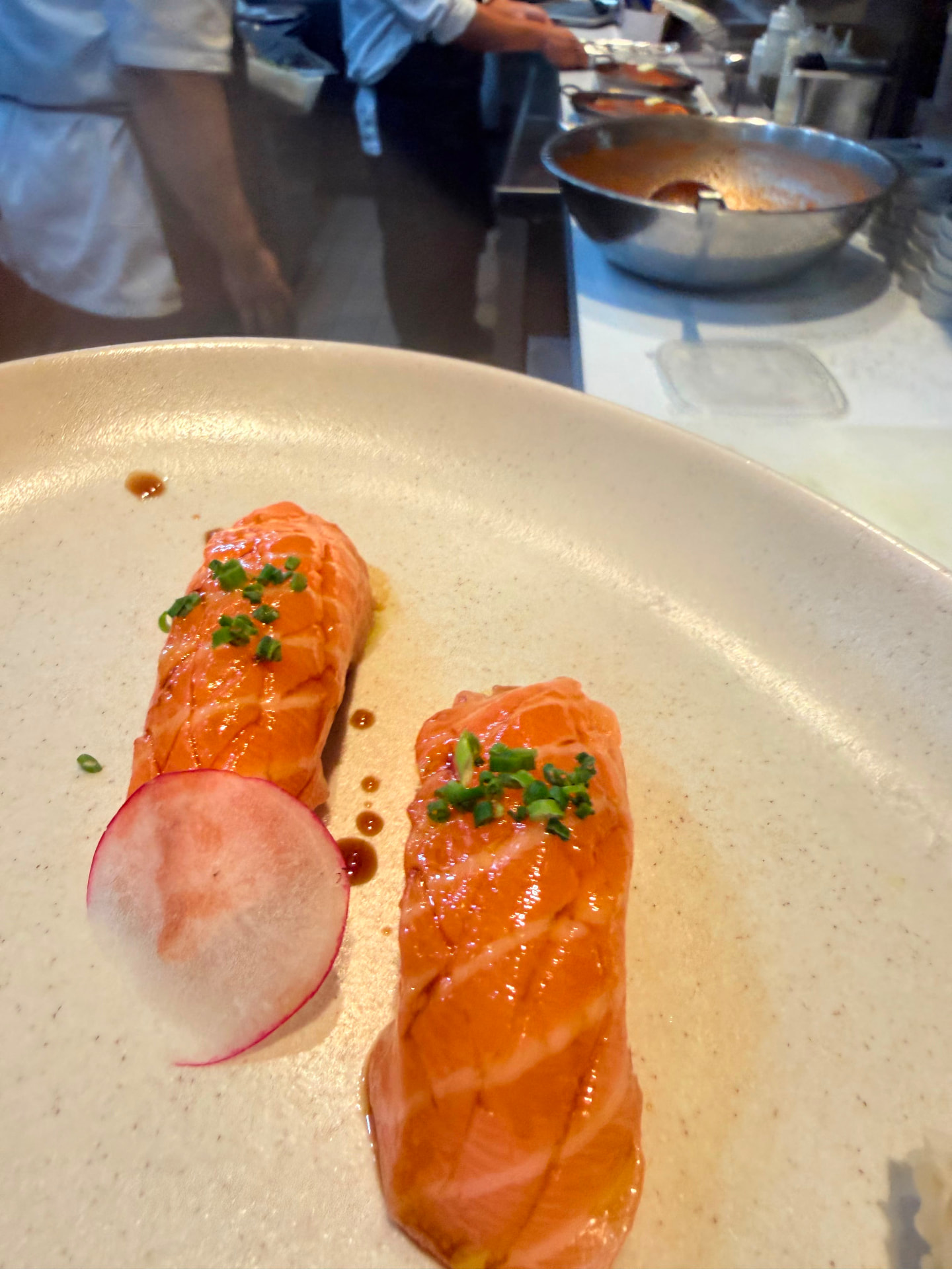 Two pieces of torched salmon nigiri with chives